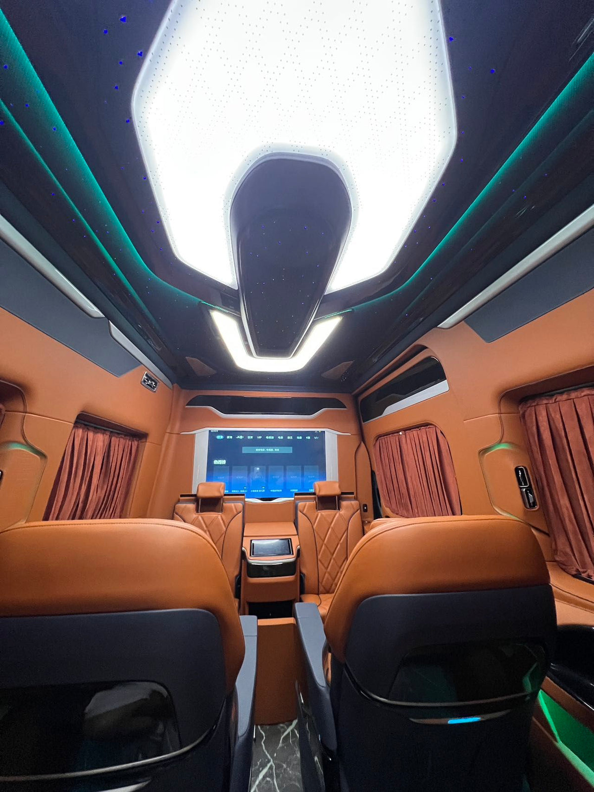 Toyota HiAce upgrade package: luxury seating, waterproof flooring, electric curtains, and a concealed bar/seating unit.