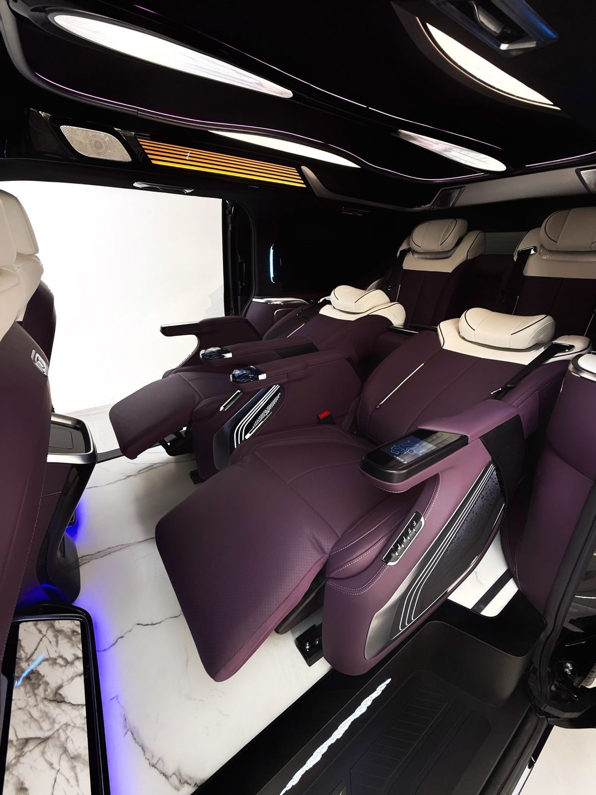 Toyota Sienna interior customization featuring luxury seats, overhead lighting, curtains, flooring, folding tables, and more.